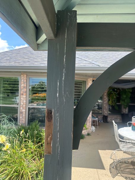 Resurface Gazebo Weathered wooden post with visible scratches, set against a home and garden background.